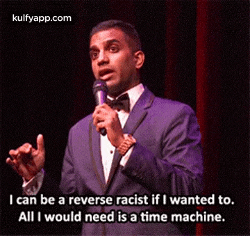 a man in a suit is holding a microphone and saying i can be a reverse racist