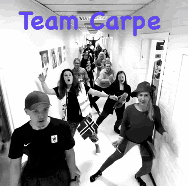 a group of people standing in a hallway with the words team carpe on the bottom