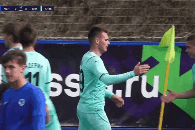 a group of soccer players are standing in front of a banner that says ' rus ' on it