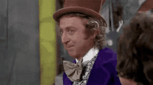 a close up of a man wearing a top hat and a purple suit .