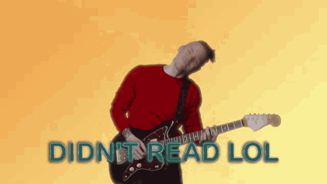 a man in a red sweater is playing a guitar with the words did n't read lol behind him