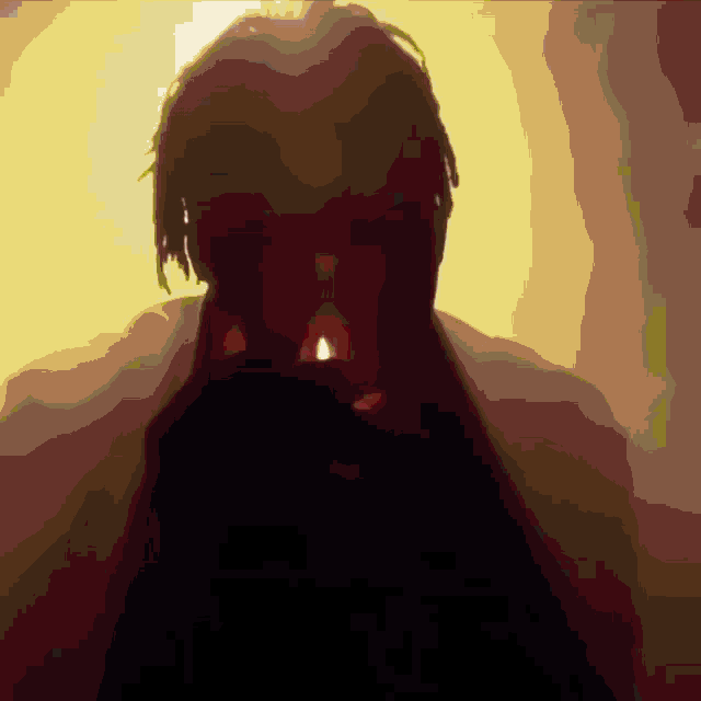 a man with dreadlocks is standing in front of a yellow light