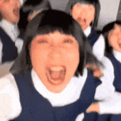 a group of girls are screaming with their mouths open .