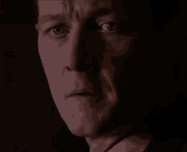 a close up of a man 's face with his eyes closed