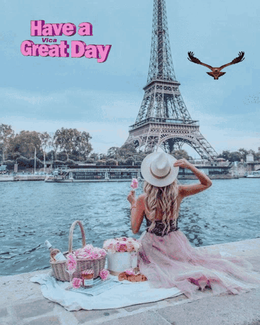 a woman sits on a blanket in front of the eiffel tower with the words have a great day on the bottom