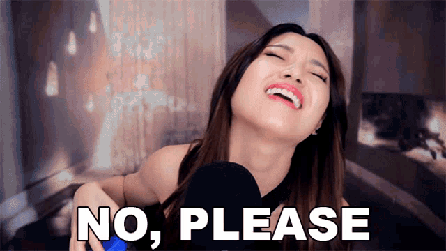 a woman is laughing and holding a microphone with the words " no please " behind her