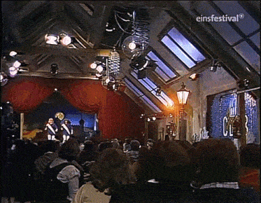a group of people are sitting in front of a stage with a sign that says einfestival on it