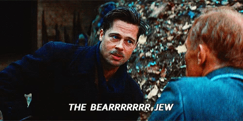 a man with a mustache is talking to another man with the words " the bearrrrrr jew " below him
