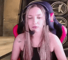 a woman wearing headphones and a microphone is sitting in a chair .