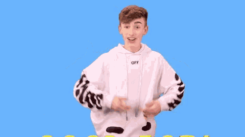 a young man in a white off white hoodie is giving a thumbs up