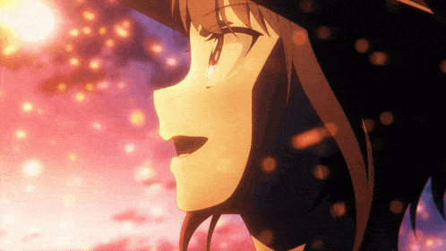 a close up of a girl 's face with the sun shining behind her