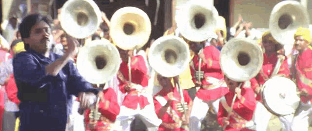 a man playing a trumpet in front of a band