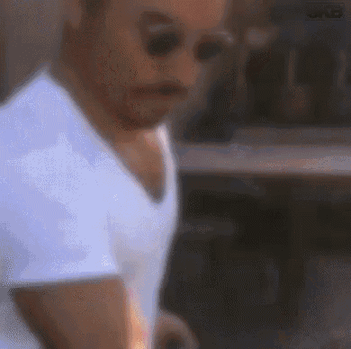 a blurry picture of a man in a white shirt and sunglasses