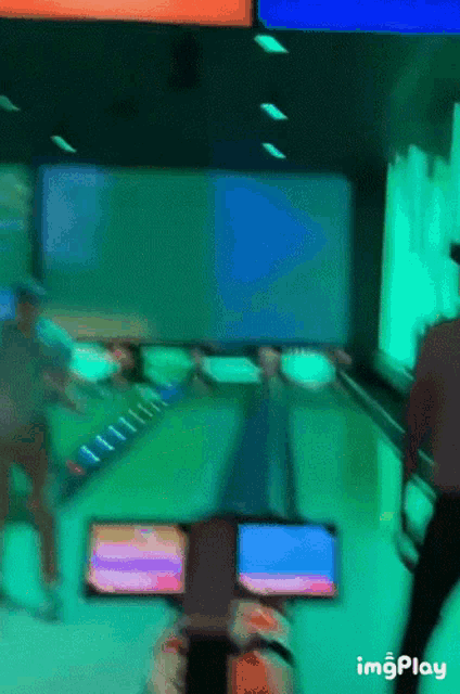 a blurry picture of a bowling alley with the words imgplay in the corner