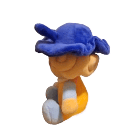 a stuffed animal wearing a blue hat and a yellow and blue outfit is sitting on a white background .