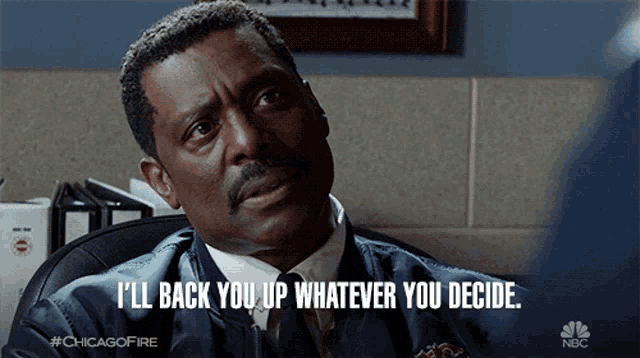a man sitting in a chair with the words " i 'll back you up whatever you decide "
