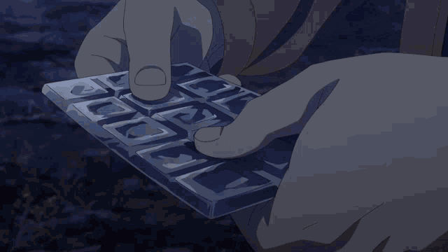 a person is holding a pair of playing cards with the letters a and k on them