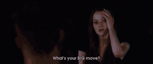 a woman is talking to a man in a dark room and says what 's your big move