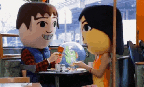 a man and a woman are sitting at a table in a diner