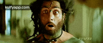 a man with a beard and dreadlocks is making a surprised face in a movie .
