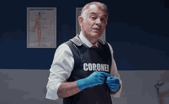 a man wearing a vest that says coroner