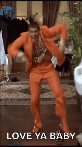 a man in an orange suit is dancing in a room with the words love ya baby on the bottom .