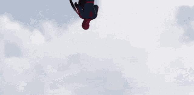 a man in a spider man suit is holding a shield with a star on it