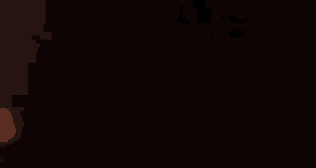 a close up of a candle burning in the dark .
