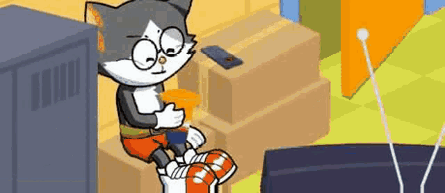 a cartoon cat is sitting in front of a television eating a snack .