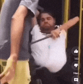 a man in a white shirt is being lifted by another man in a chair .