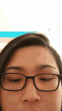 a close up of a woman 's face with glasses