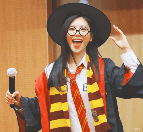a woman in a harry potter costume holding a microphone