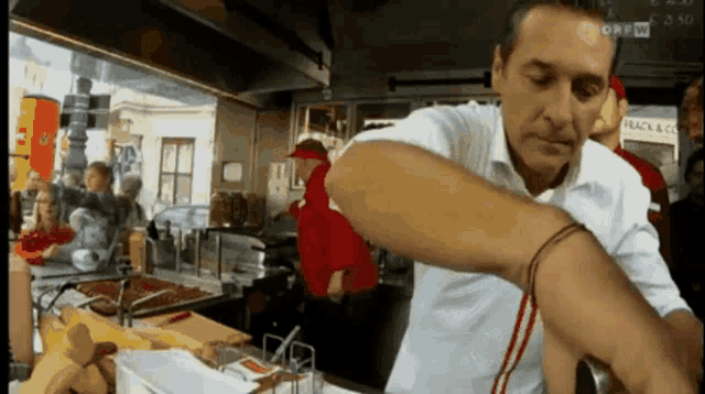 a man prepares food in front of a sign that says huck & co