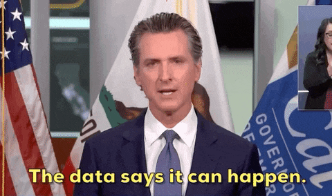 a man in a suit and tie says " the data says it can happen " in front of an american flag