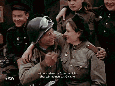 a group of soldiers are posing for a picture and one of them is wearing a helmet