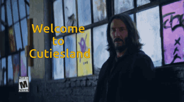 a man is standing in front of a window with the words welcome to cutiesland