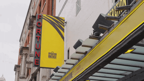 a yellow sign on the side of a building that says fortune