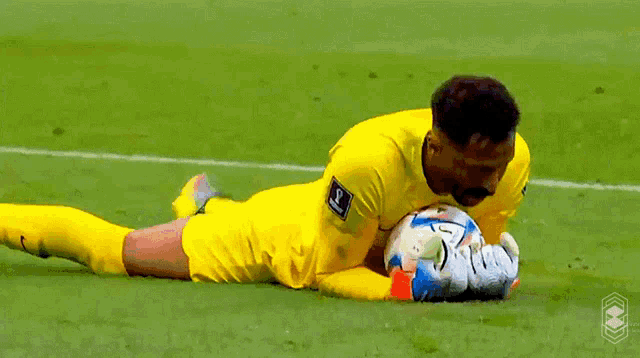 a soccer player with the letter s on his shirt is laying on the field