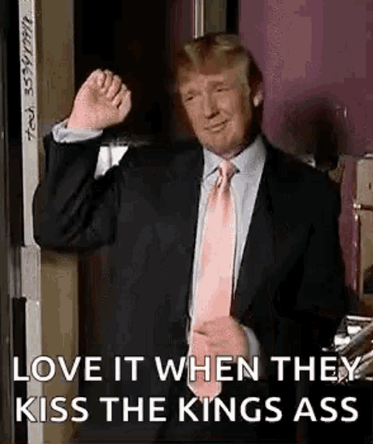 donald trump is wearing a suit and pink tie and making a funny face .