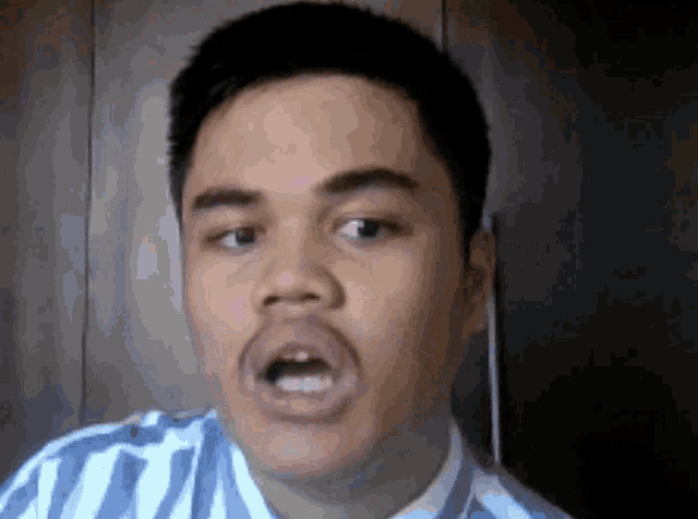 a close up of a man 's face with his mouth wide open