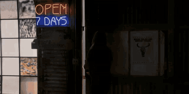 a neon sign that says open 7 days hangs above a welcome sign
