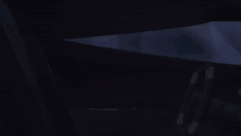 a silhouette of a person in a dark room with a white light coming out of them