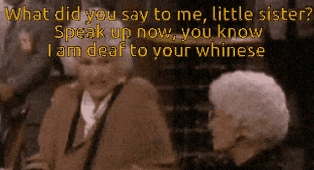 a man in a suit and tie is talking to another man in a suit