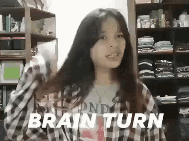 a girl in a plaid shirt is standing in front of a closet and the words brain turn are on the screen