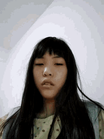 a close up of a girl 's face with her eyes closed and her mouth open