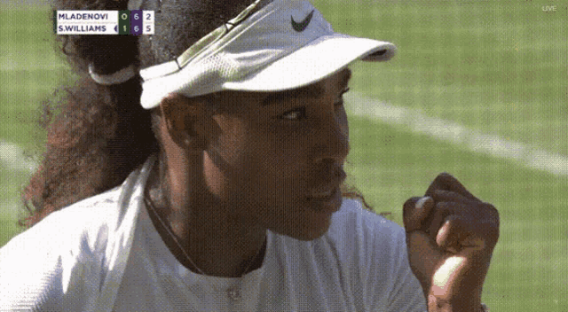 a woman wearing a white nike visor is watching a tennis match between mladenovi and s. williams