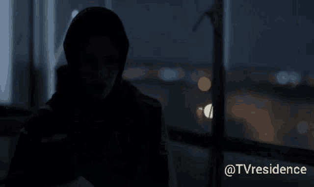 a man in a hooded jacket is standing in front of a window with the hashtag @tvresidence