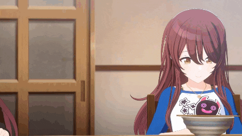 a girl sitting at a table with a bowl of food on it
