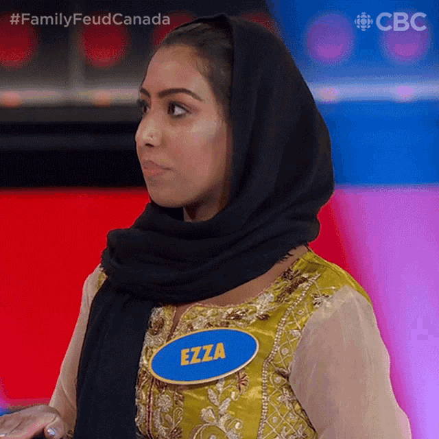 a woman wearing a hijab and a name tag with the name ezza on it