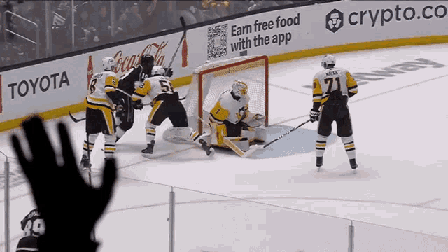 a hockey game is being played in front of a crypto.co banner